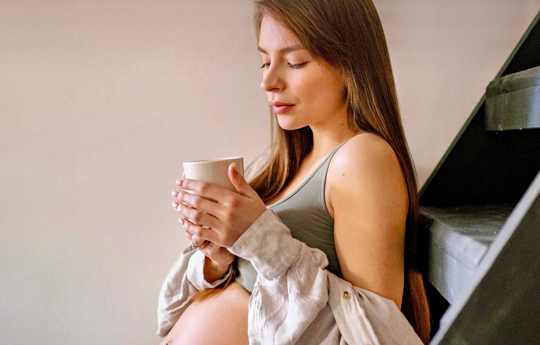 pregnant woman enjoying a delicious decaf coffee from decafhub
